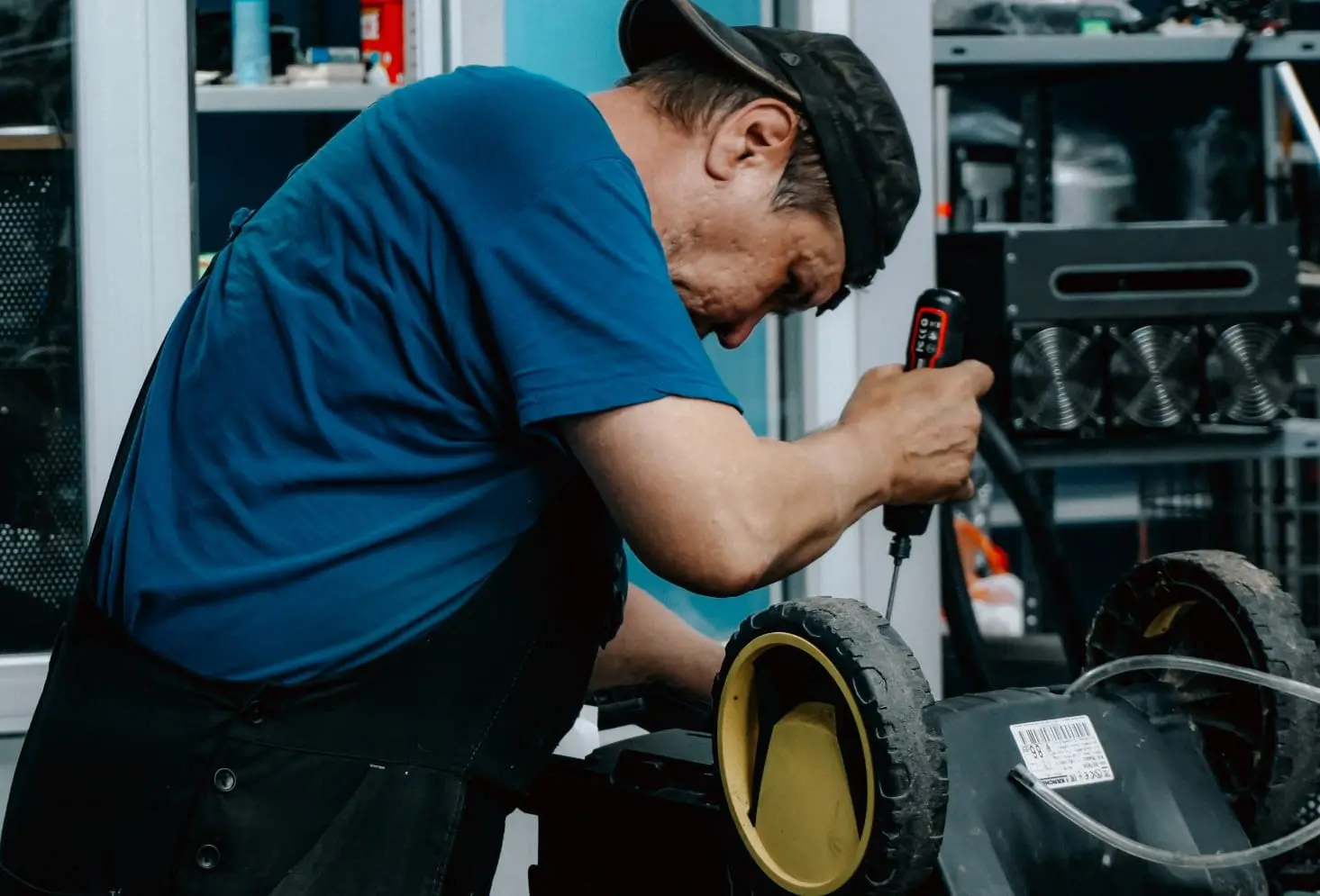 Technician using a power tool to repair residential equipment during a same-day service call